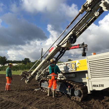 Drilling and placing tubes into field plots
