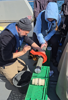 Photo of scientists working onboard a resaerch vessel
