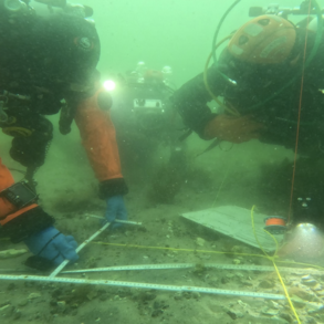 Underwater photo showing aracheological measurements on the seafloor