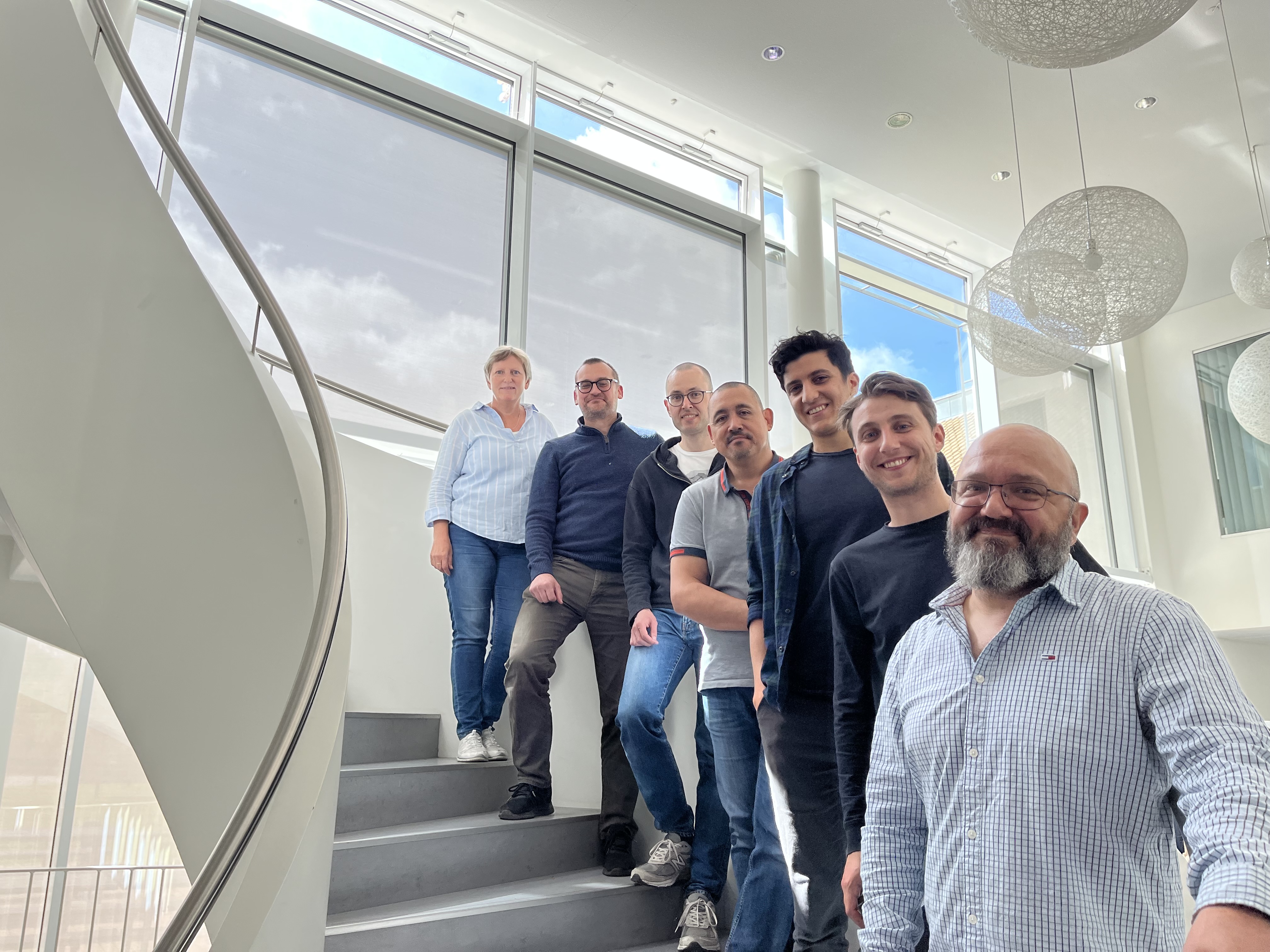 Seven persons standing on a staircase