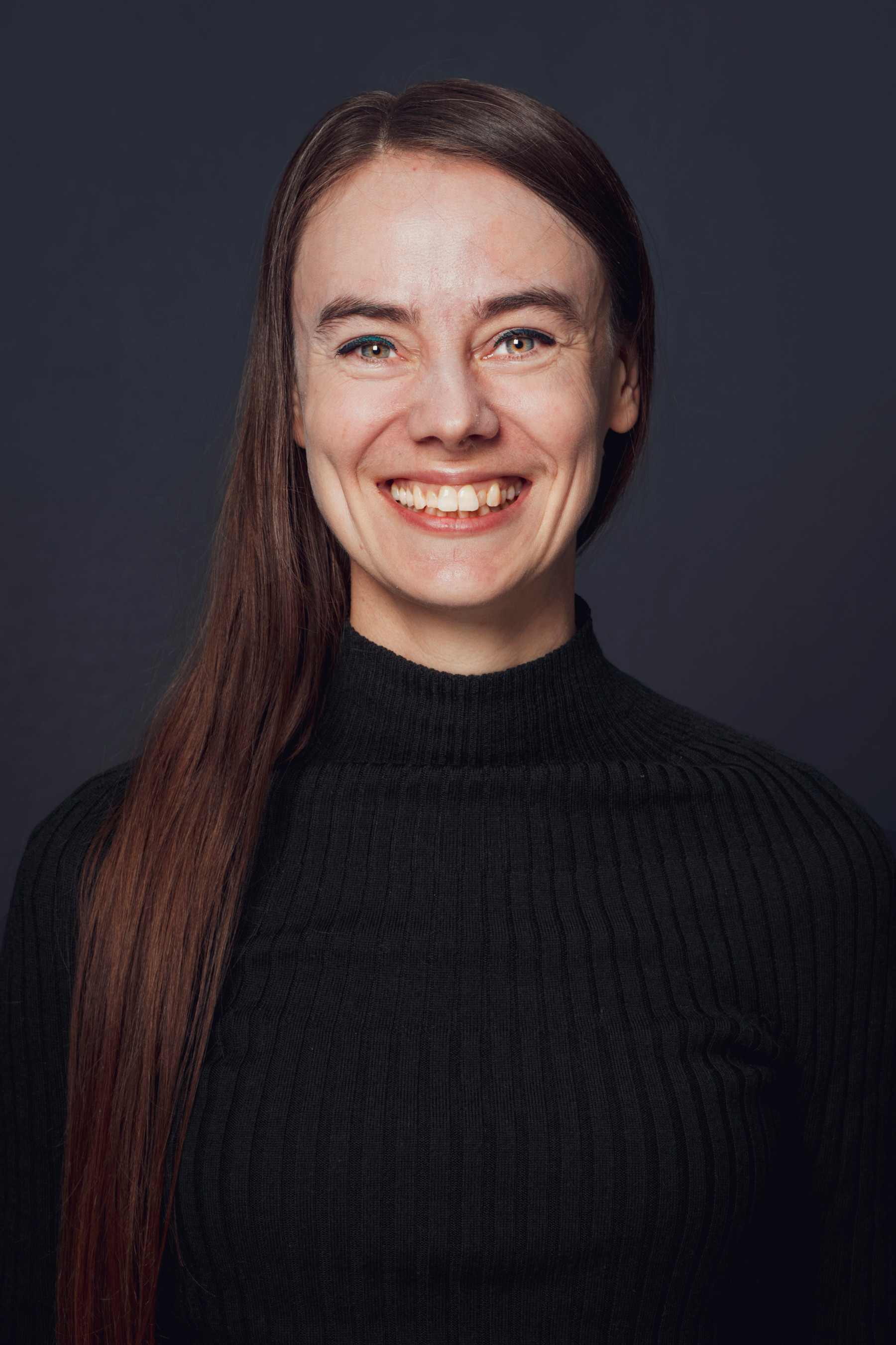 Photo of Marieke smiling in a black top