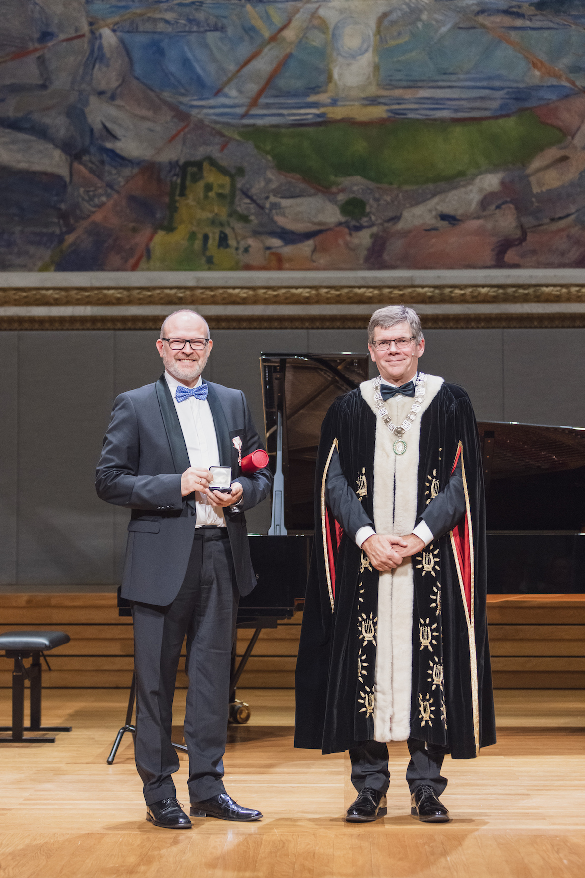 Poul Nissen in dark blue suit and light blue bow tie in award ceremony hall.